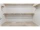 Walk-in closet with built-in wooden shelving and storage at 13569 S 175Th Dr, Goodyear, AZ 85338