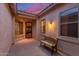 Enclosed courtyard with tiled floors, bench seating, and metal security door under the covered porch area at 13569 S 175Th Dr, Goodyear, AZ 85338