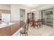 Charming dining area features a table, china cabinet, and sliding glass doors to the backyard at 13569 S 175Th Dr, Goodyear, AZ 85338