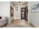 Inviting foyer with tiled flooring, decorative security door, and neutral color palette with modern artwork at 13569 S 175Th Dr, Goodyear, AZ 85338