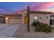 Charming desert home with tile roof, two-car garage, and a beautiful cactus landscape under a vibrant sunset at 13569 S 175Th Dr, Goodyear, AZ 85338