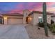 Single-story desert home with a tile roof, two-car garage, and native landscaping in a peaceful setting at 13569 S 175Th Dr, Goodyear, AZ 85338