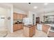 Open kitchen featuring an island, stainless appliances, and a breakfast area with decorative touches at 13569 S 175Th Dr, Goodyear, AZ 85338