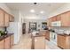 Spacious kitchen with stainless steel appliances, a central island, and an adjoining dining area at 13569 S 175Th Dr, Goodyear, AZ 85338