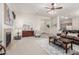 Inviting living room featuring a fireplace, hardwood furniture, and seamless flow into the kitchen area at 13569 S 175Th Dr, Goodyear, AZ 85338