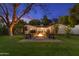 Relaxing backyard featuring a fire pit surrounded by Adirondack chairs, perfect for outdoor entertaining and cozy evenings at 141 E Bonita Way, Tempe, AZ 85281
