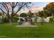 Lush backyard featuring a fire pit, outdoor seating, and mature trees at 141 E Bonita Way, Tempe, AZ 85281