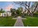 Inviting backyard featuring a fire pit, outdoor seating, and a storage shed at 141 E Bonita Way, Tempe, AZ 85281
