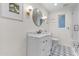 Bright bathroom features a vanity with marble countertop, patterned tile floor, and modern fixtures at 141 E Bonita Way, Tempe, AZ 85281