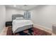 A bedroom features a gray bed frame, a corner window with shutters, and a decorative rug at 141 E Bonita Way, Tempe, AZ 85281