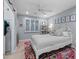 A charming bedroom features a white bed frame, vibrant rug, and a ceiling fan for added comfort at 141 E Bonita Way, Tempe, AZ 85281