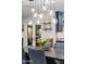 Dining room with modern chandelier above table with blue upholstered chairs at 141 E Bonita Way, Tempe, AZ 85281