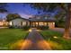 Inviting home with a brick pathway leading to a modern front door and a well-maintained lawn, beautifully lit at twilight at 141 E Bonita Way, Tempe, AZ 85281