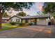 Charming single-story home with a manicured lawn, a covered entrance, and a brick driveway under a beautiful sky at 141 E Bonita Way, Tempe, AZ 85281
