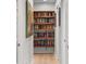 Hallway with built-in wooden bookshelves filled with books at 141 E Bonita Way, Tempe, AZ 85281