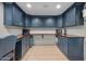 A stylish home office features blue cabinets, a spacious wooden countertop, and modern appliances at 141 E Bonita Way, Tempe, AZ 85281
