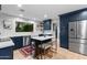 Stylish kitchen with navy cabinets, a central island, stainless steel appliances, and a bright, airy atmosphere at 141 E Bonita Way, Tempe, AZ 85281