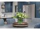 Bright kitchen with navy cabinets, stainless steel appliances, and fresh flowers at 141 E Bonita Way, Tempe, AZ 85281