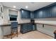 Well-lit home office with built-in desk, cabinets, and a large window at 141 E Bonita Way, Tempe, AZ 85281
