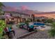 Expansive backyard featuring a pool, spa, lush landscaping, and an outdoor dining area at 14294 W Edgemont Ave, Goodyear, AZ 85395