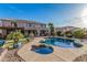 Resort style backyard featuring a pool, spa, and manicured landscaping at 14294 W Edgemont Ave, Goodyear, AZ 85395