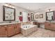 Primary bathroom featuring double sinks, vanity and separate soaking tub at 14294 W Edgemont Ave, Goodyear, AZ 85395