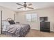 Neutral bedroom with black furniture, carpet, and ceiling fan at 14294 W Edgemont Ave, Goodyear, AZ 85395