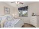 Cozy bedroom with white furniture, soft natural light, and peaceful decor at 14294 W Edgemont Ave, Goodyear, AZ 85395