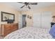 Neutral bedroom featuring a double sliding door closet and carpet at 14294 W Edgemont Ave, Goodyear, AZ 85395