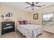 Bright bedroom featuring neutral tones, art, carpet, and a ceiling fan at 14294 W Edgemont Ave, Goodyear, AZ 85395