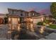 Large two-story home featuring a three-car garage and inviting entrance at 14294 W Edgemont Ave, Goodyear, AZ 85395