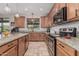 Well-appointed kitchen featuring granite countertops, stainless steel appliances, and travertine flooring at 14294 W Edgemont Ave, Goodyear, AZ 85395