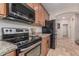 Cozy kitchen features stainless steel appliances, granite counters, and tile flooring at 14294 W Edgemont Ave, Goodyear, AZ 85395