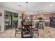 Eat-in kitchen with a chandelier over the table and a large sliding glass door to the backyard at 14294 W Edgemont Ave, Goodyear, AZ 85395