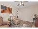 Comfortable living room with cozy seating, ceiling fan, and view into dining room at 14294 W Edgemont Ave, Goodyear, AZ 85395