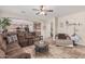 Spacious living room with tile floors, ceiling fan, and open access to the kitchen at 14294 W Edgemont Ave, Goodyear, AZ 85395