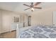 Bright main bedroom with white furniture, ceiling fan, and carpet flooring at 14294 W Edgemont Ave, Goodyear, AZ 85395