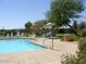 Community pool featuring lounge chairs, shaded seating, and well-maintained landscaping at 14294 W Edgemont Ave, Goodyear, AZ 85395
