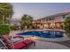 Beautiful outdoor space featuring a sparkling pool, lounge chairs and pergola with string lights at 14294 W Edgemont Ave, Goodyear, AZ 85395