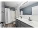 This bathroom boasts a double vanity, plank flooring, a shower with curtain, and a standard toilet at 1466 E Avenida Fresca --, Casa Grande, AZ 85122
