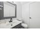 Half bathroom featuring a gray vanity, white counter top, square mirror, and white toilet at 1466 E Avenida Fresca --, Casa Grande, AZ 85122