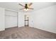 This cozy bedroom boasts plush carpeting, a ceiling fan, and access to the upstairs hallway at 1466 E Avenida Fresca --, Casa Grande, AZ 85122