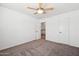 This cozy bedroom boasts plush carpeting, a ceiling fan, and access to the upstairs hallway at 1466 E Avenida Fresca --, Casa Grande, AZ 85122