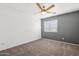 This bright bedroom features plush carpeting, a ceiling fan, and a neutral color palette at 1466 E Avenida Fresca --, Casa Grande, AZ 85122