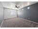 This bedroom features plush carpeting, a ceiling fan, and bright natural light from smaller windows at 1466 E Avenida Fresca --, Casa Grande, AZ 85122
