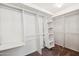 This walk-in closet features built-in shelving, hanging rods, and plush carpeting at 1466 E Avenida Fresca --, Casa Grande, AZ 85122