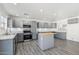 Updated kitchen with gray cabinetry, stainless steel appliances, a kitchen island, and wood-look flooring at 1466 E Avenida Fresca --, Casa Grande, AZ 85122