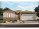 Charming single-story home with a stone-accented facade, desert landscaping, and a two-car garage at 147 N 175Th Ave, Goodyear, AZ 85338
