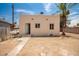 View of the backyard, featuring a palm tree and block wall surrounding the property at 1505 W Fillmore St, Phoenix, AZ 85007