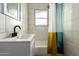 This bathroom has tile walls, a modern vanity, and a shower/tub combo with a colorful curtain at 1505 W Fillmore St, Phoenix, AZ 85007